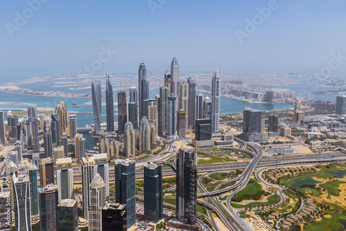 Aerial view of modern skyscrapers and sea in the background, Dubai, UAE.