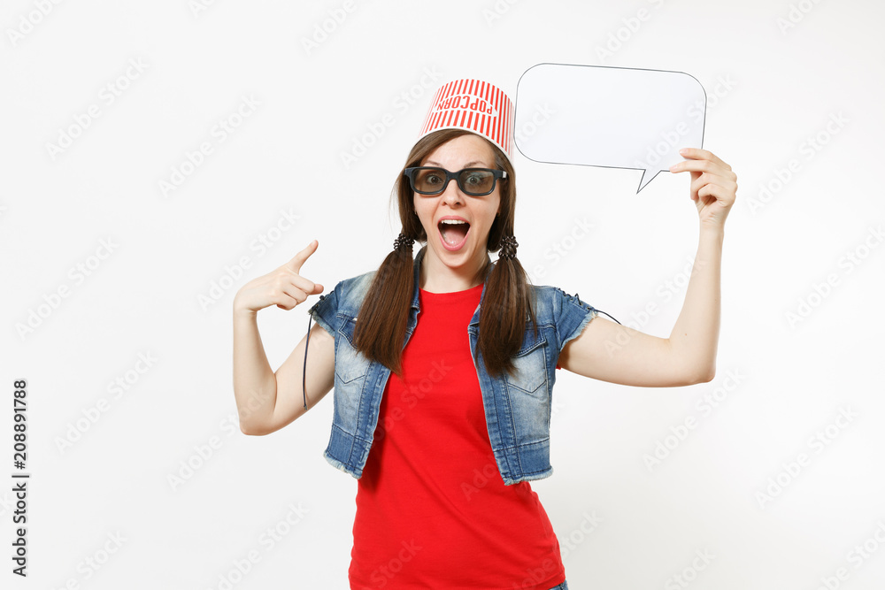 Surprised woman in 3d glasses with bucket for popcorn on head watching movie film, poiting index finger on say cloud with place for text, copy space isolated on white background. Emotions in cinema. Surprised woman in 3d glasses with bucket for popcorn on head watching movie film, poiting index finger on say cloud with place for text, copy space isolated on white background. Emotions in cinema.