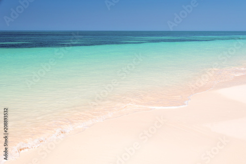 Sand and caribbean sea background © Delphotostock