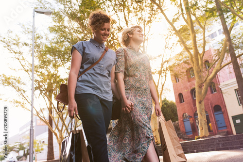 Young lesbian couple enjoying a day shopping in the city photo