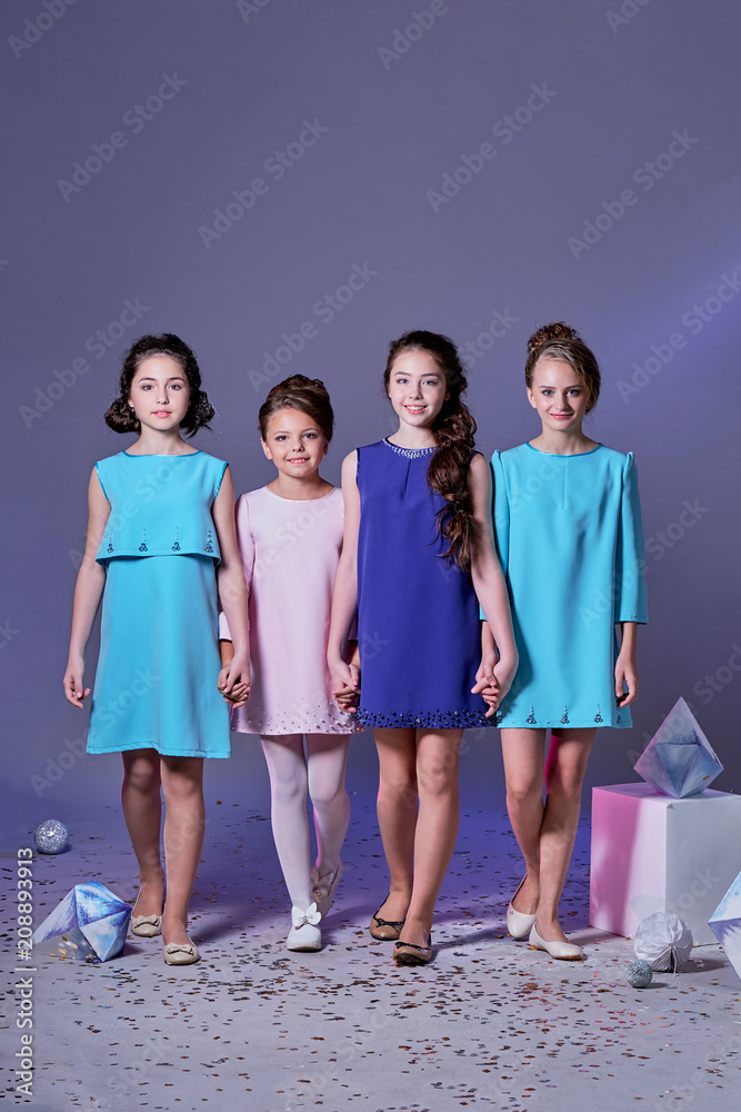 Group 4 happy smiling young teen girls. Fashion lady teenager.Stylish  elegant four children posing studio in blue dresses, catalog clothes.  Girlfriends in beautiful womanly dresses for event,holiday Stock Photo -  Alamy