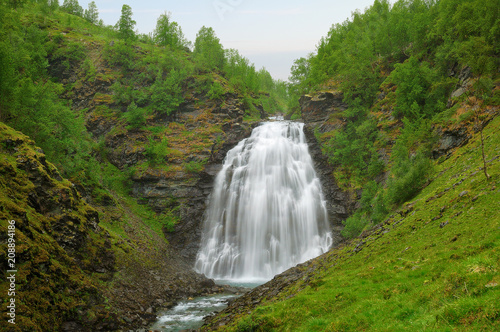 Long exposure image of the Dalfossen Waterfall. Lyngen Alps mountains  Norway. Nature landscape.