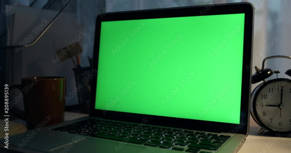 Laptop with green screen. Dark office. Dolly move right to left. Perfect to put your own image or video.Green screen of technology being used. Chroma Key laptop Laptop with green screen. Dark office. Dolly move right to left. Perfect to put your own image or video.Green screen of technology being used. Chroma Key laptop