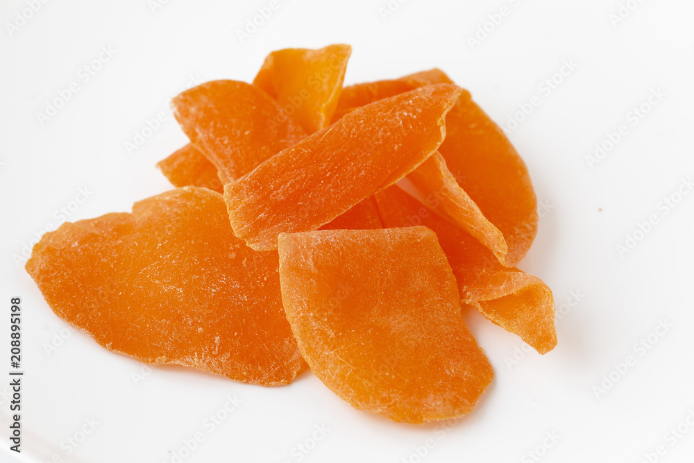 Close-up of dried mango pieces. Isolated on white Close-up of dried mango pieces. Isolated on white