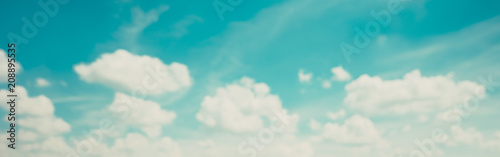 Blur defocused image of blue sky with clouds