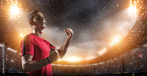Happy soccer player with goal joy in the 3d imaginary stadium background.