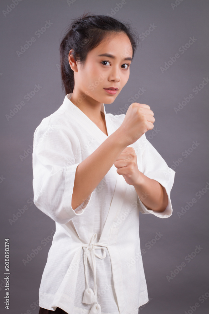 woman fighter portrait; asian woman practicing martial arts, mixed martial arts, MMA, kick boxing, karate studio isolated portrait; girl fighter training concept; 20s young adult asian woman model woman fighter portrait; asian woman practicing martial arts, mixed martial arts, MMA, kick boxing, karate studio isolated portrait; girl fighter training concept; 20s young adult asian woman model