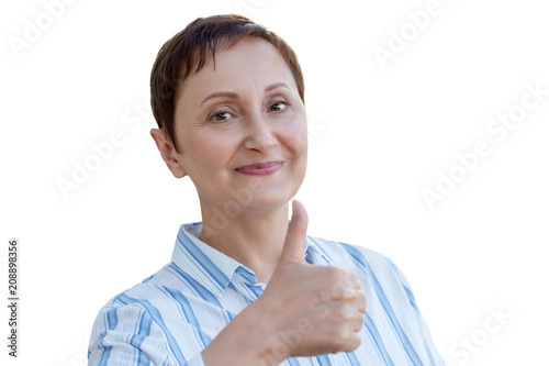 Woman giving thumbs up, the thumb sign of approval, okay. Closeup portrait of middle aged woman isolated on white background