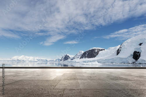 empty brick ground with sonw mountain as background photo