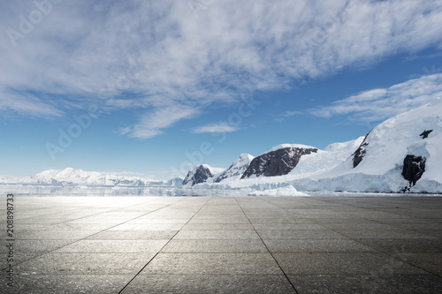 empty brick ground with sonw mountain as background photo