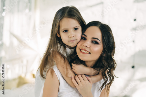 Mother and daughter laying in bed. Family relations concept.