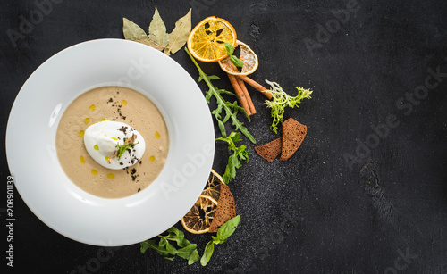 Mushroom cream soup on black background