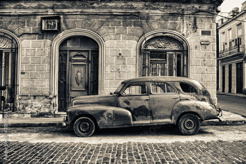 black and white tone of old chevrolet parked in the street of havana © javier