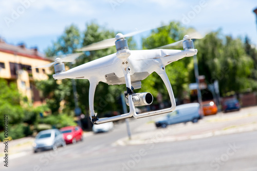 The manned Dron is flying over the city.