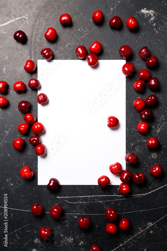 Cherry berry red color flat lay view on table with white empty blank mock up board