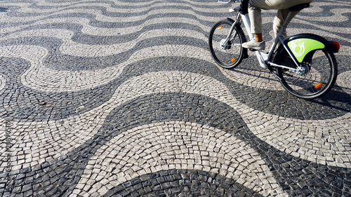 Bicycle on Lisbon pavement pavement (Calçada portuguesa) in Lisbon, Portugal. Praça Dom Pedro IV.    