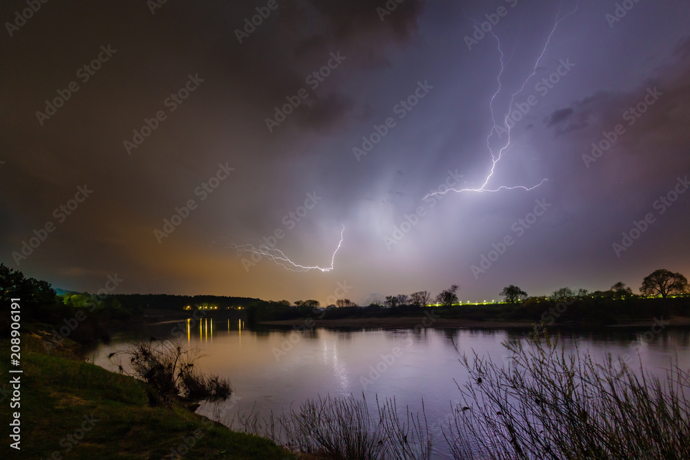 Rain and lightning above the river