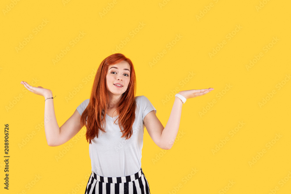 What to do. Nice red haired woman shrugging her shoulders while not knowing what to do What to do. Nice red haired woman shrugging her shoulders while not knowing what to do