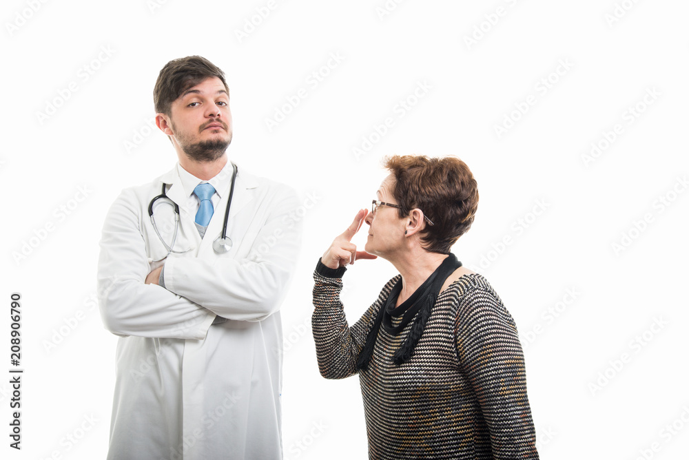 Female patient making look into my eyes gesture to doctor Female patient making look into my eyes gesture to doctor