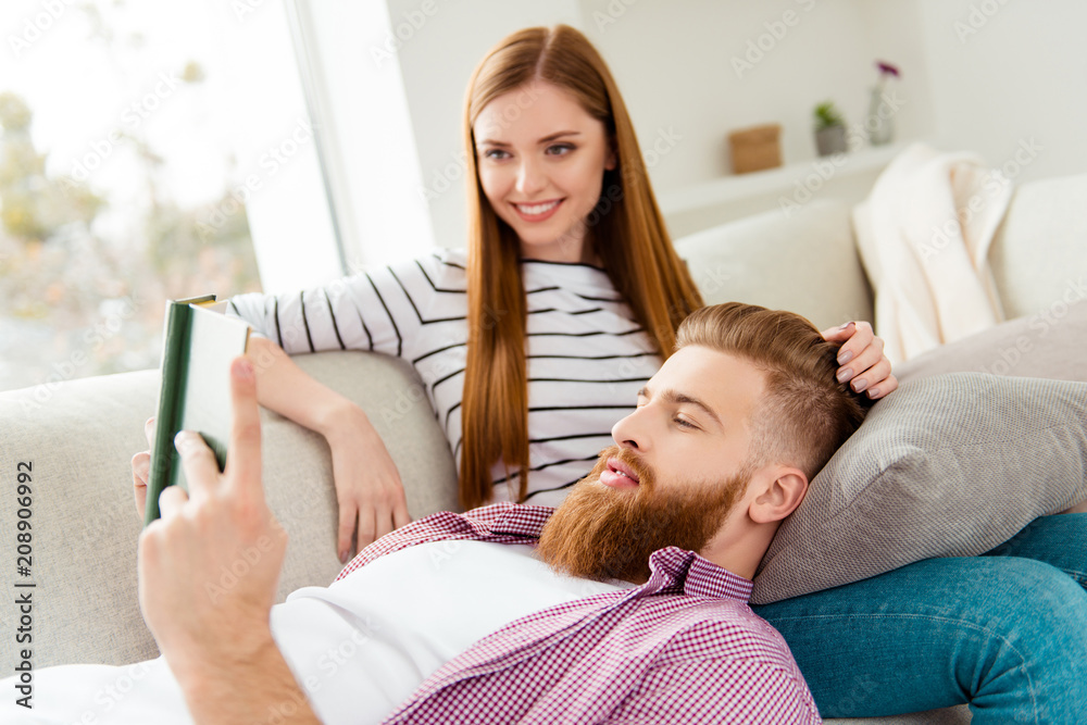 Leisure lifestyle gentle partners dream dreamy chat talk conversation care trust concept. Handsome lovely careful cute excited cheerful guy reading love story to his adorable lady lying on her legs Leisure lifestyle gentle partners dream dreamy chat talk conversation care trust concept. Handsome lovely careful cute excited cheerful guy reading love story to his adorable lady lying on her legs