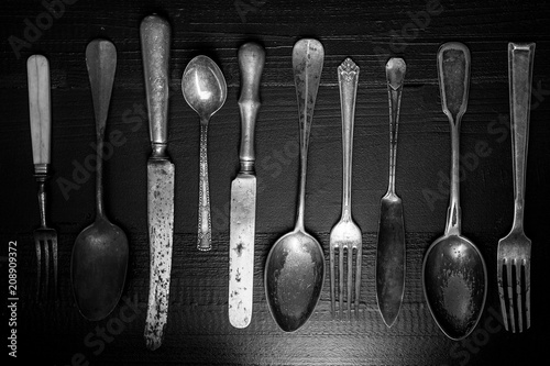 Rustic Cutlery on Old Dark Wooden Background. Silverware and Food Concept.