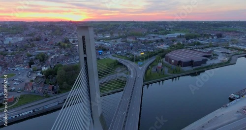 Aerial view of steel cable bridge crossing in Belgium. Road in perspective. European bridge over a river at sunset. photo