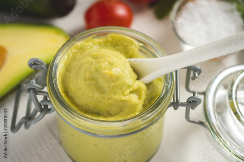 Homemade Green Avocado Spread in Jar. Vegan Raw and Healthy Fresh Food Concept.