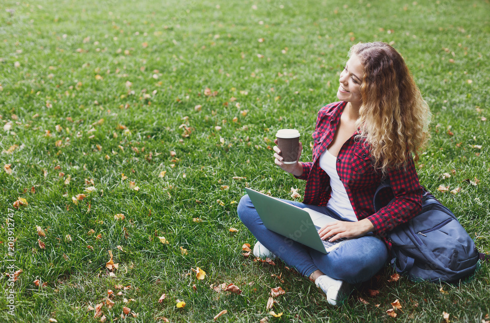 Beautiful young woman using a laptop outdoors Beautiful young woman using a laptop outdoors