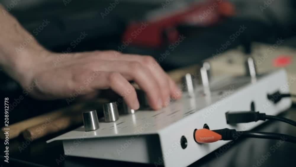 Extremely close up shot of musician's hand tune synthesizer Extremely close up shot of musician's hand tune synthesizer