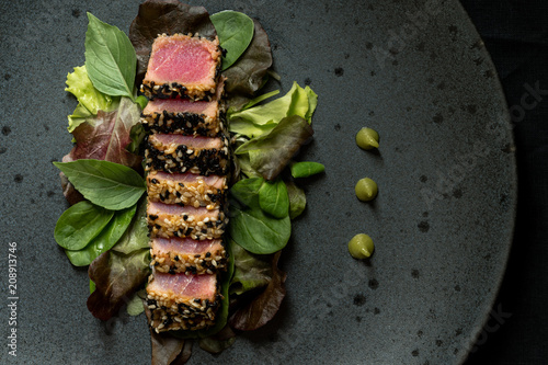 Grilled Sliced Tuna Steak in Sesame with Salad and Wasabi Sauce photo