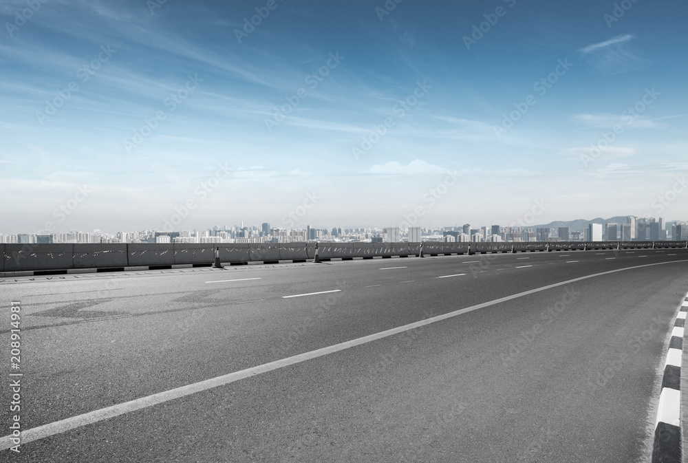 empty road with city skyline empty road with city skyline