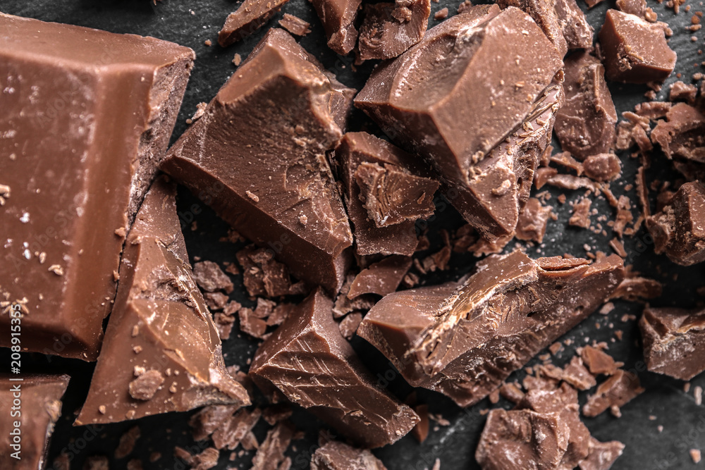 Pieces of chocolate on dark background, closeup Pieces of chocolate on dark background, closeup