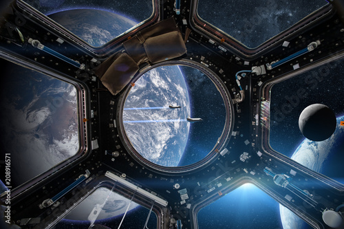 Fototapeta Naklejka Na Ścianę i Meble -  View from a porthole of space station on the Earth background. Elements of this image furnished by NASA.