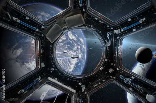 Fototapeta Naklejka Na Ścianę i Meble -  View from a porthole of space station on the Earth background. Elements of this image furnished by NASA.