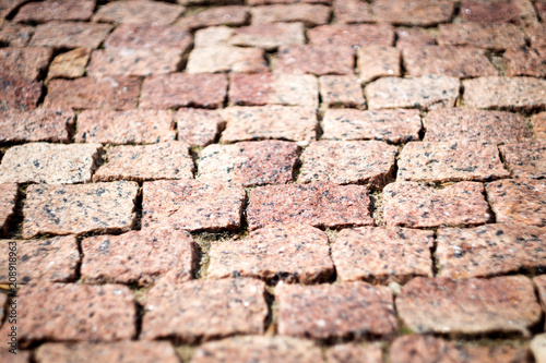 red-brown rectangular uneven paving close-up