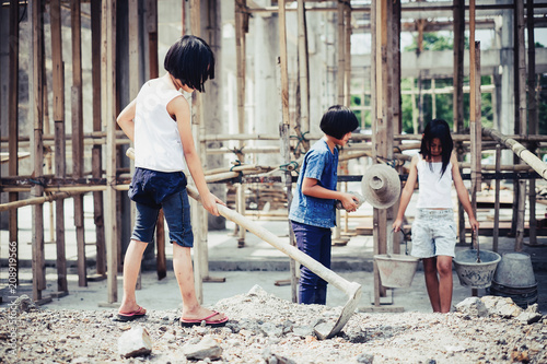 Group of little girl labor working in commercial building structure, World Day Against Child Labour concept.