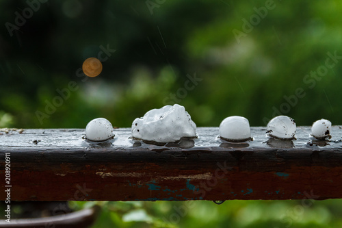 Pieces of ice on the railing after hailstorm