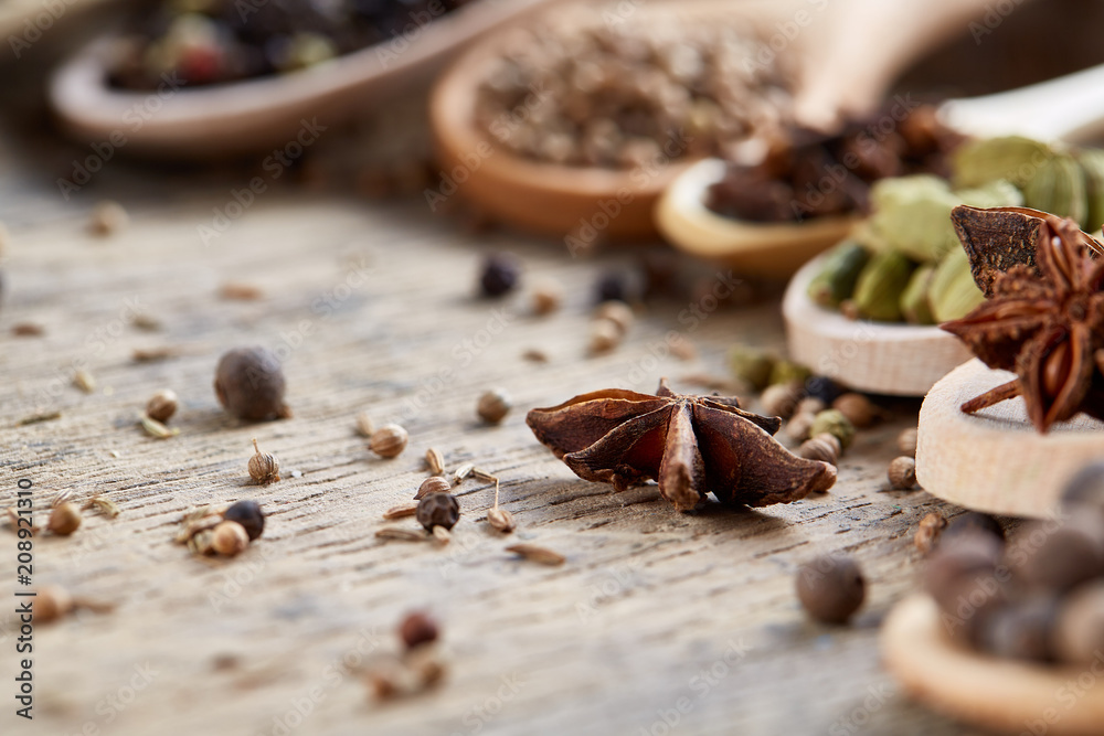 Spoons with aromatic various spices for cooking on old wooden board, close-up, flat lay, shallow depth of field. Spoons with aromatic various spices for cooking on old wooden board, close-up, flat lay, shallow depth of field.
