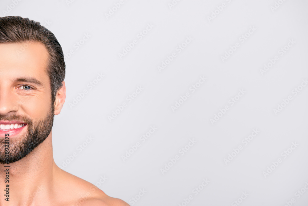 Half face cropped portrait with copy space of cheerful, joyful, virile, manly, attractive, naked, unshaven, handsome, stunning man with ideal, perfect face skin, looking at camera over gray background Half face cropped portrait with copy space of cheerful, joyful, virile, manly, attractive, naked, unshaven, handsome, stunning man with ideal, perfect face skin, looking at camera over gray background