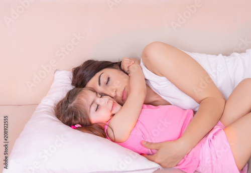 Portrait of mother and her daughter sleep together