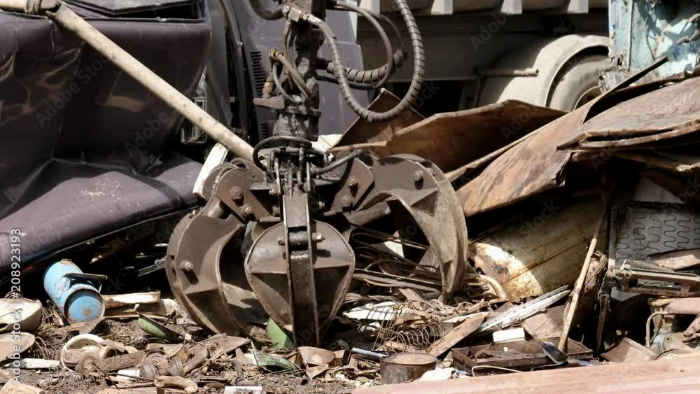 Claws of mechanical moving arm in scrapyard Claws of mechanical moving arm in scrapyard
