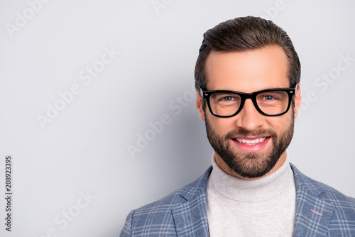 Portrait with copy space of attractive, gentlemen, manly, intelligent, cheerful man with beaming smile, looking at camera over gray background © deagreez