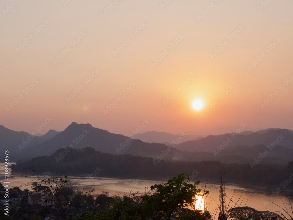 Aerial shot of river coast and mountain landscape during Sunset