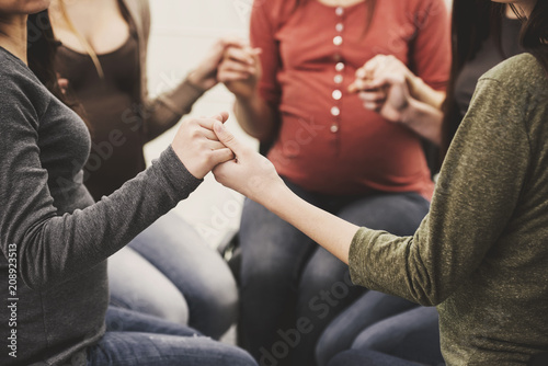 Fototapeta Naklejka Na Ścianę i Meble -  Close up.Young pregnant girls in circle hold hands