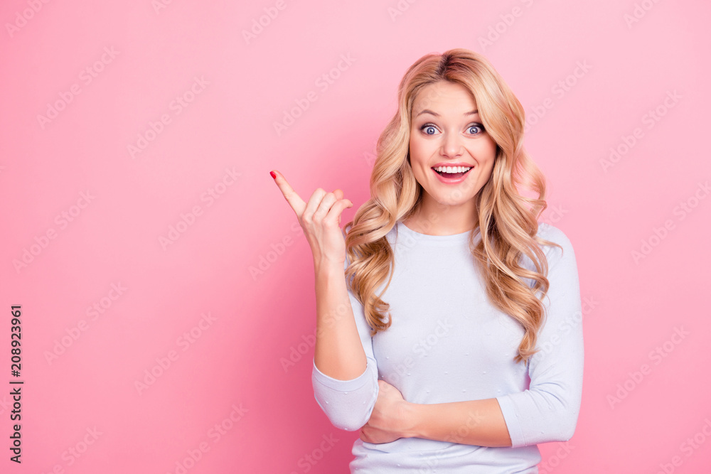 Portrait with empty place of astonished excited creative girl with modern hairdo pointing to copyspace looking at camera isolated on pink background. Choice recommend concept Portrait with empty place of astonished excited creative girl with modern hairdo pointing to copyspace looking at camera isolated on pink background. Choice recommend concept