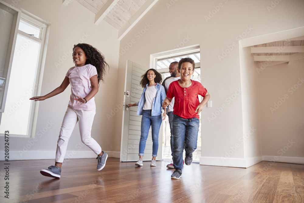 Family Opening Door And Walking In Empty Lounge Of New Home Family Opening Door And Walking In Empty Lounge Of New Home