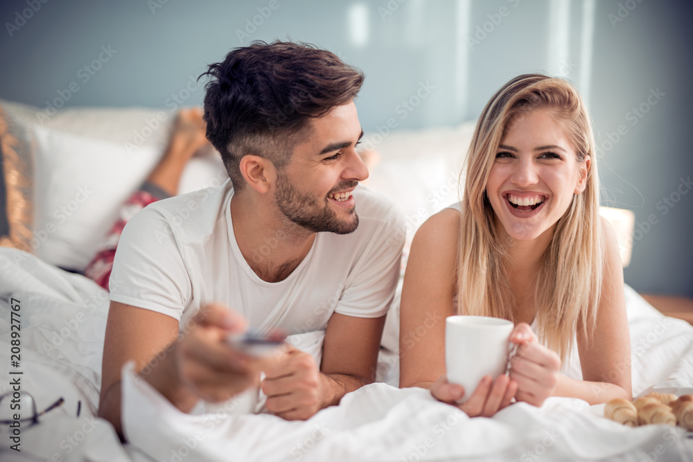 Young couple having a breakfast in the bed Young couple having a breakfast in the bed
