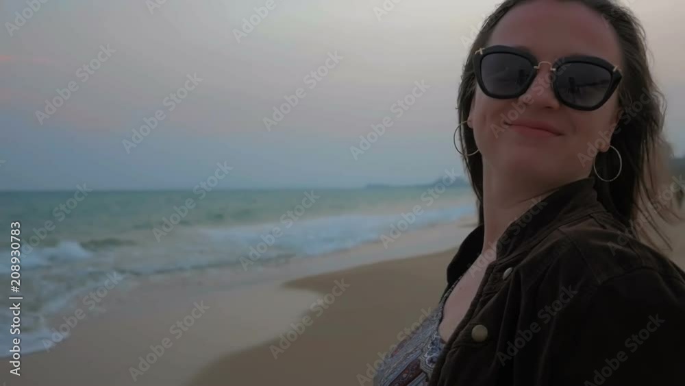 Portrait of a happy young girl on the coastline of the summer sea. Close up shot. Slow motion. Portrait of a happy young girl on the coastline of the summer sea. Close up shot. Slow motion.