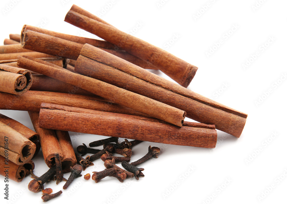 Cinnamon sticks and cloves on white background Cinnamon sticks and cloves on white background