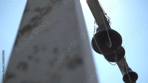 Close up shot of a church bell against background with blue sky. photo